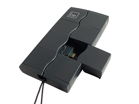 BE-Modular In Vehicle Monitoring System Black modular electronic device with a segmented casing partially opened, revealing an internal circuit board and connected cables.